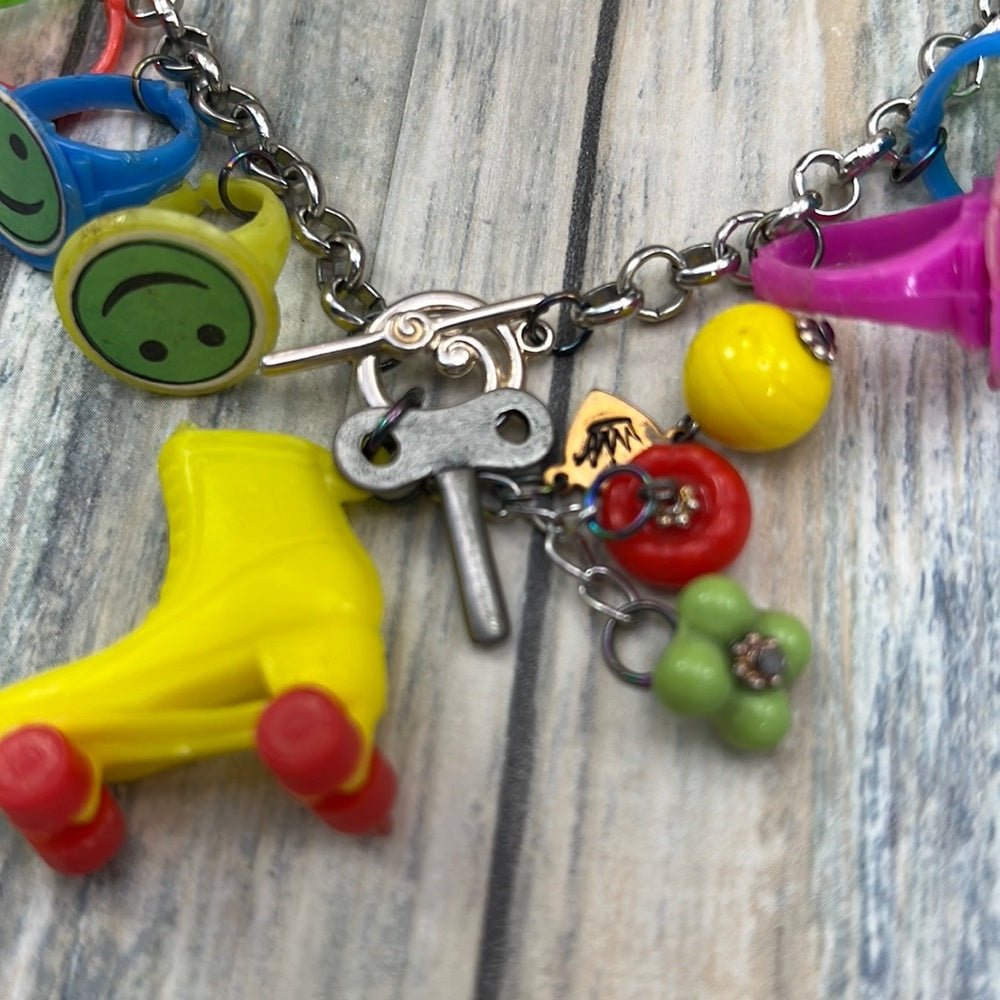 Adorned Crown artisan assemblage child’s roller skate happy face necklace