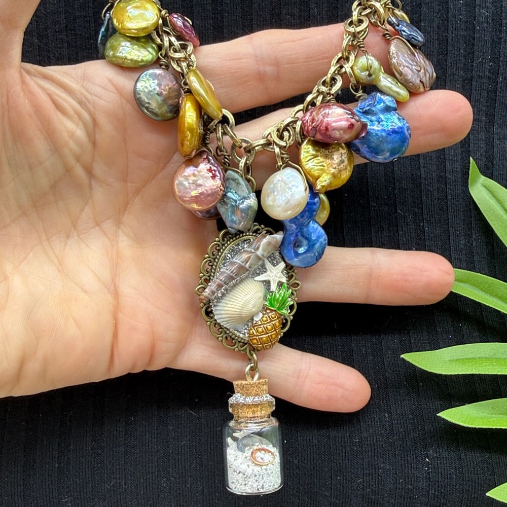 Adorned Crown Jewelry assemblage Pearl seascape bottle of sand shells necklace