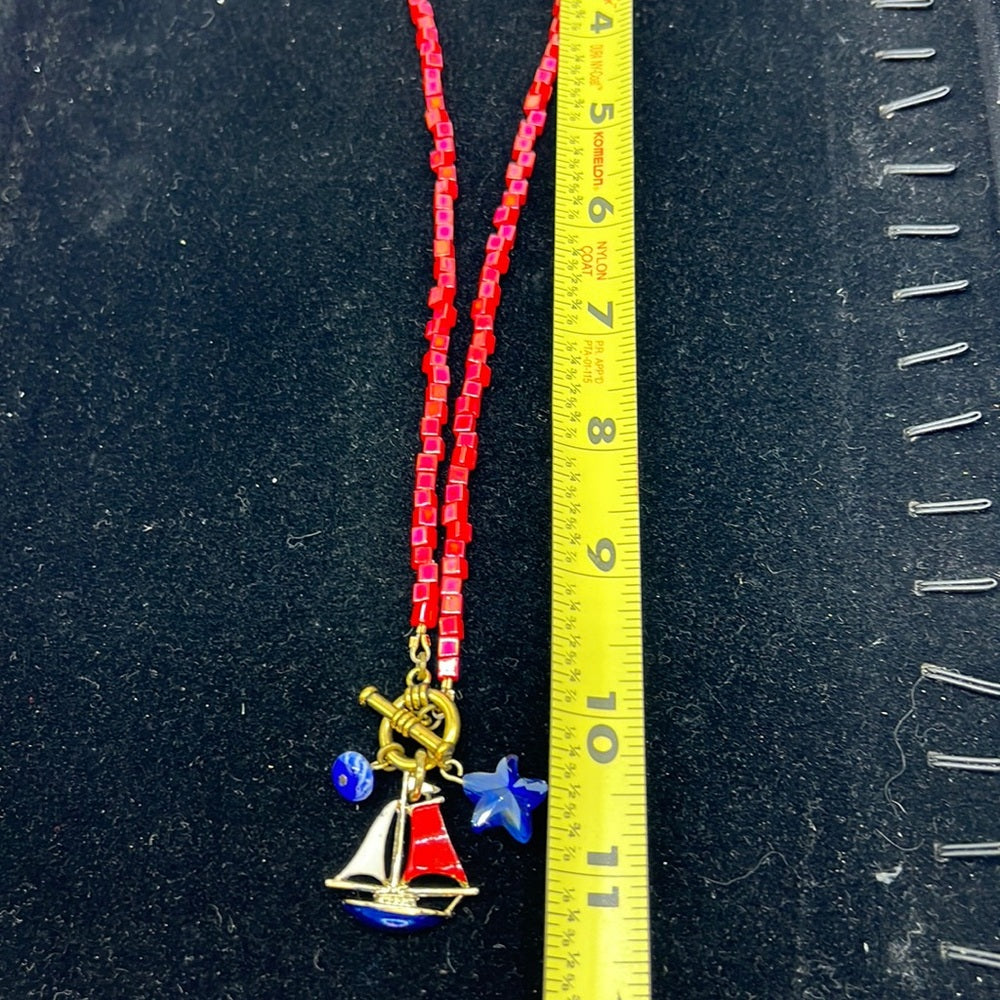 Adorned Crown Assemblage beaches & butterflies bead sailboat charm necklace