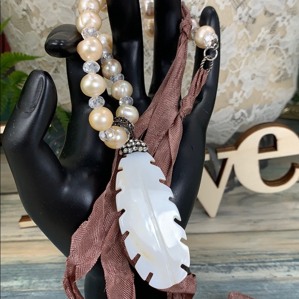 Adorned Crown artisan assemblage carved shell feather pearl silk necklace