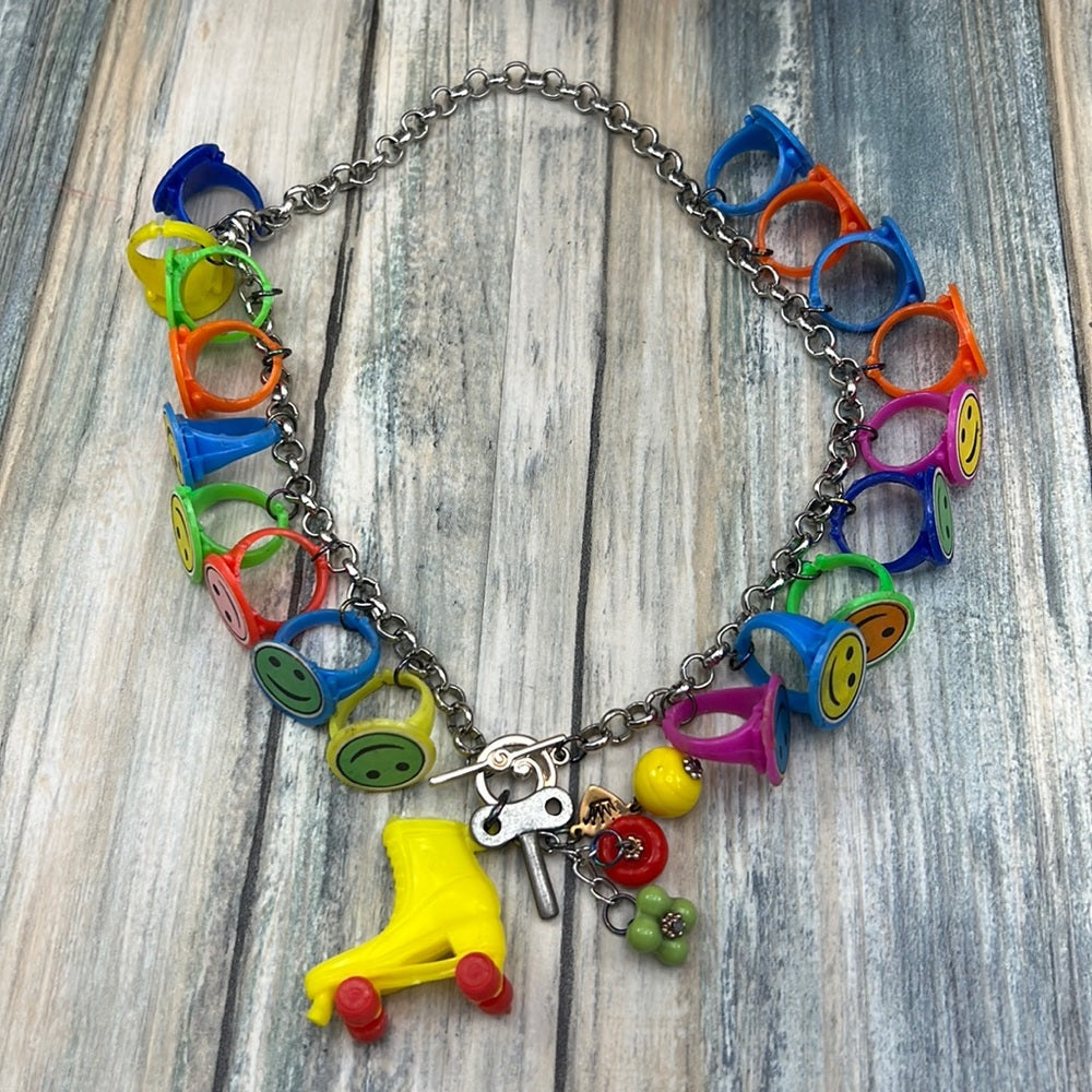 Adorned Crown artisan assemblage child’s roller skate happy face necklace