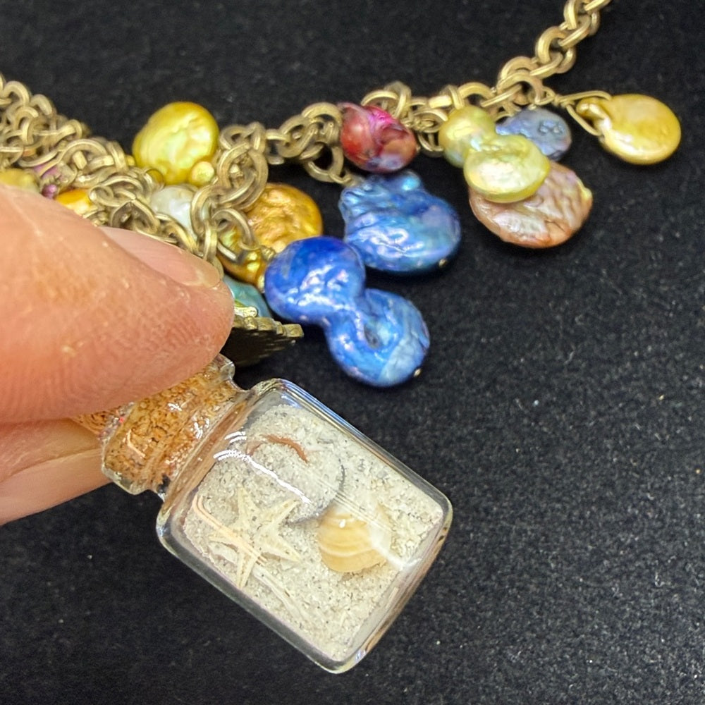 Adorned Crown Jewelry assemblage Pearl seascape bottle of sand shells necklace