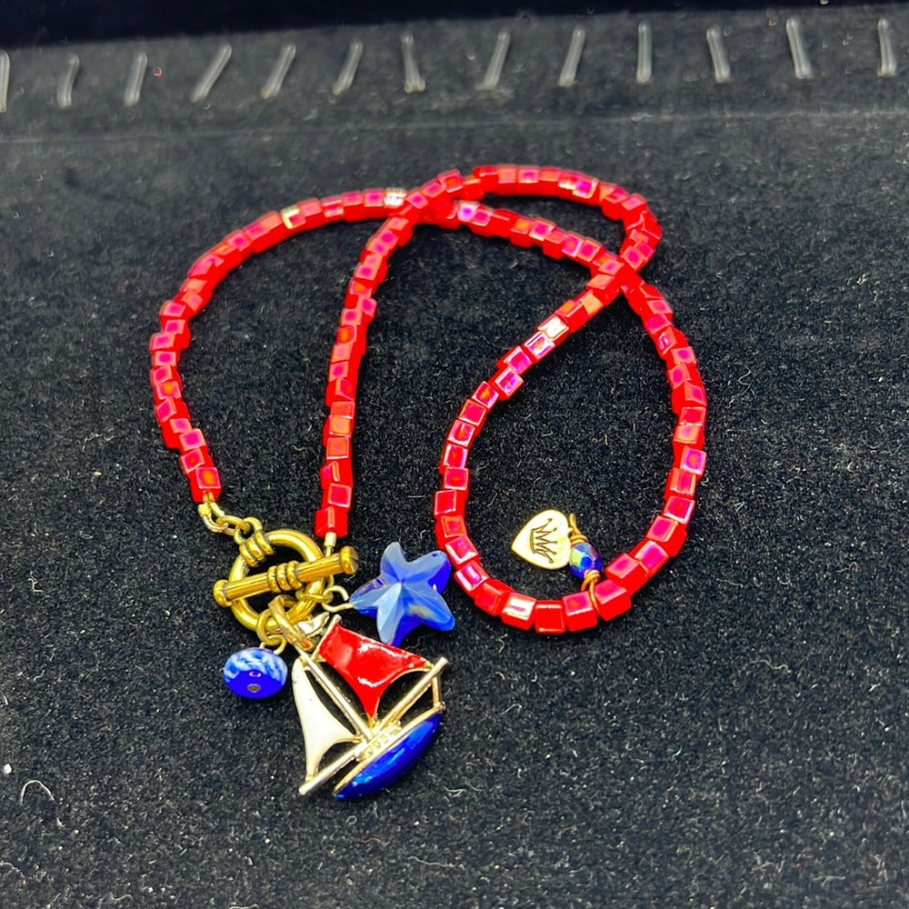Adorned Crown Assemblage beaches & butterflies bead sailboat charm necklace