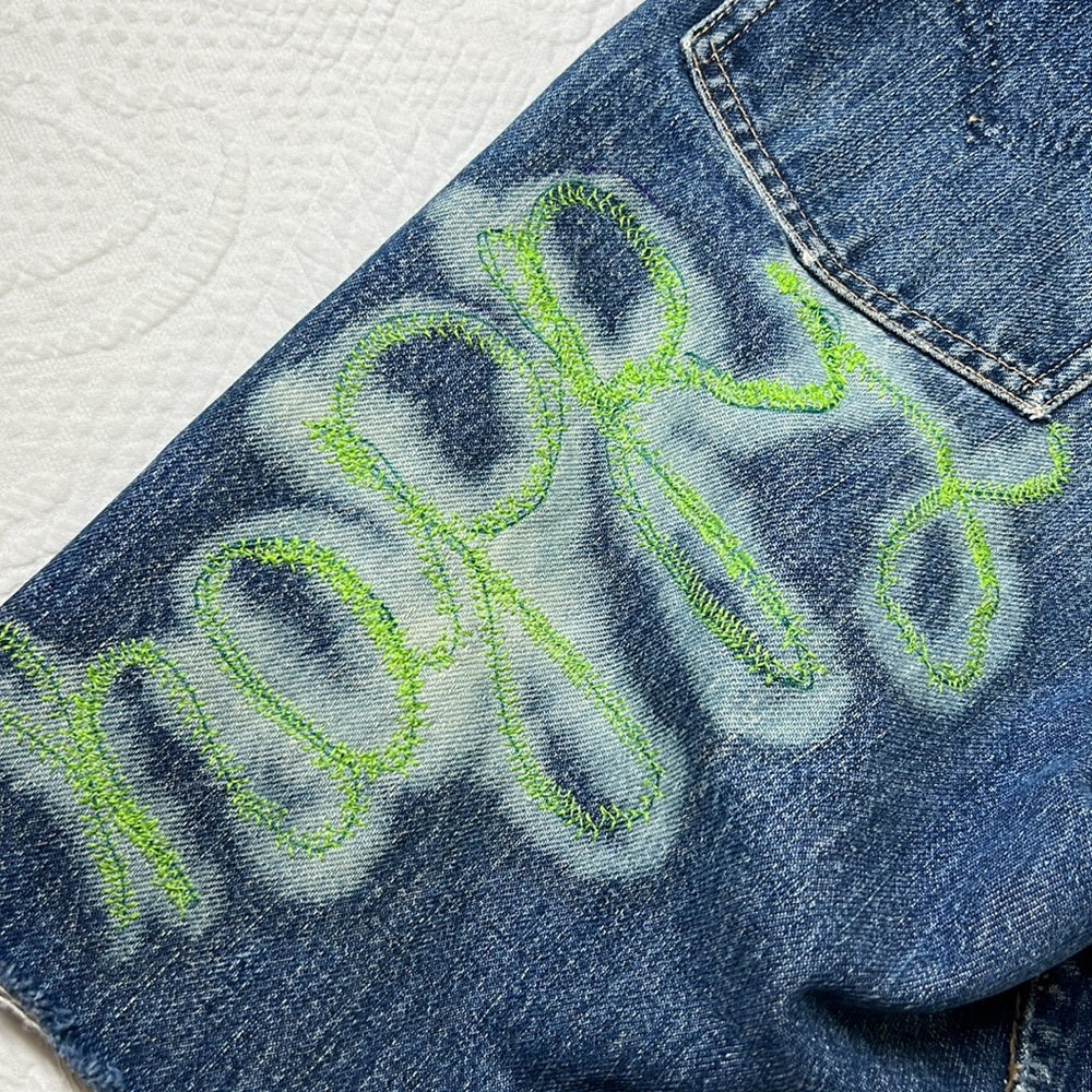 Adorned Crown Textile reworked patch Big E Levi’s cut off shorts upcycle