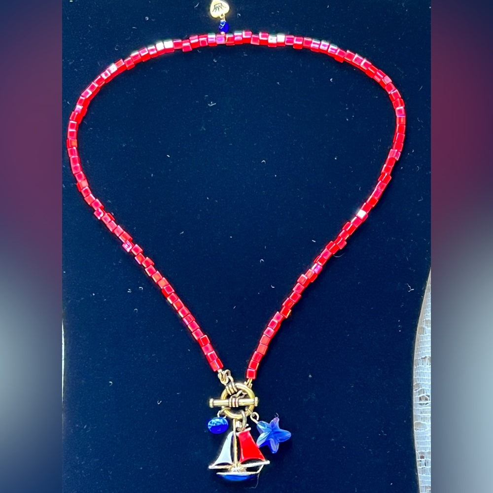 Adorned Crown Assemblage beaches & butterflies bead sailboat charm necklace