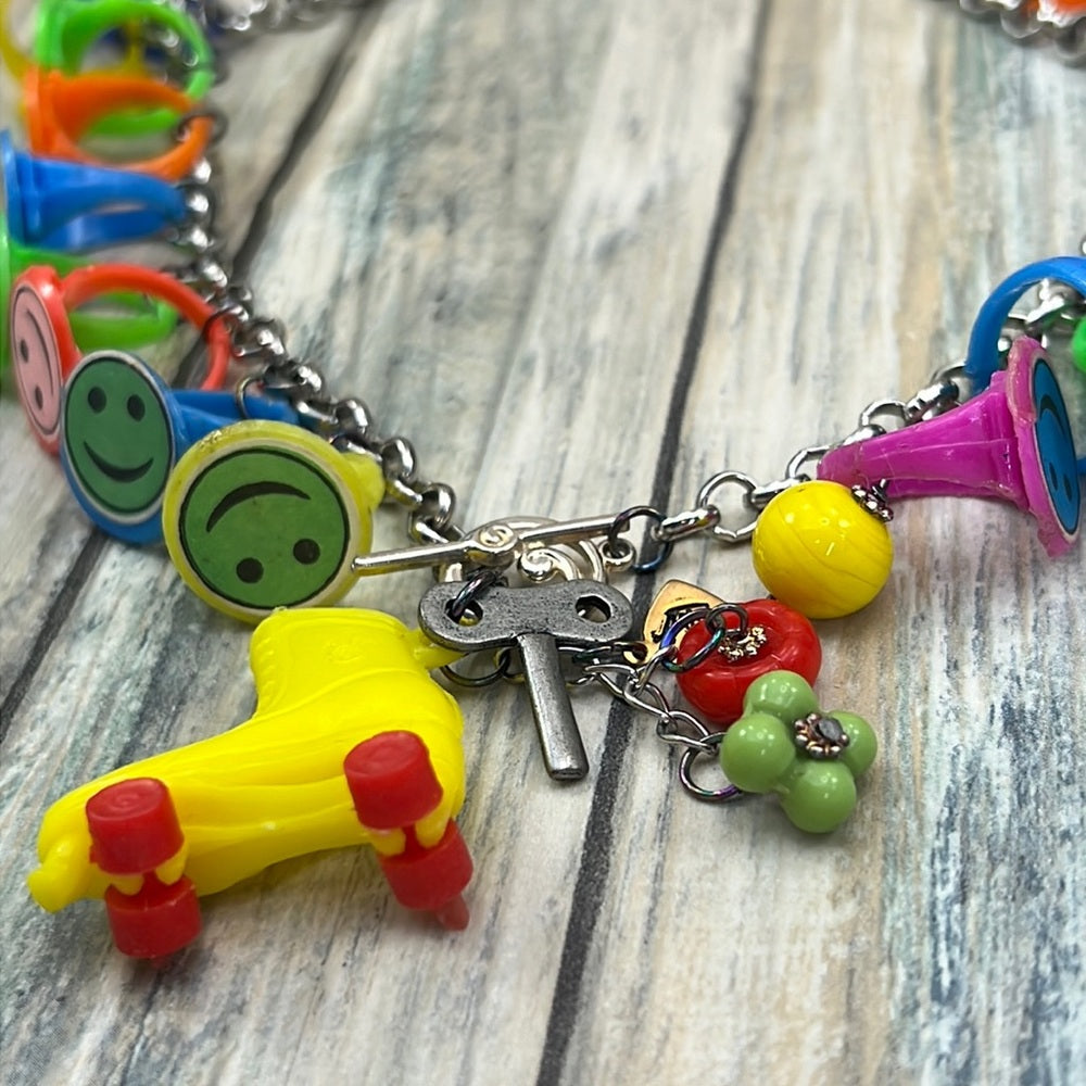 Adorned Crown artisan assemblage child’s roller skate happy face necklace
