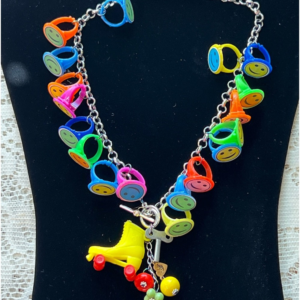 Adorned Crown artisan assemblage child’s roller skate happy face necklace