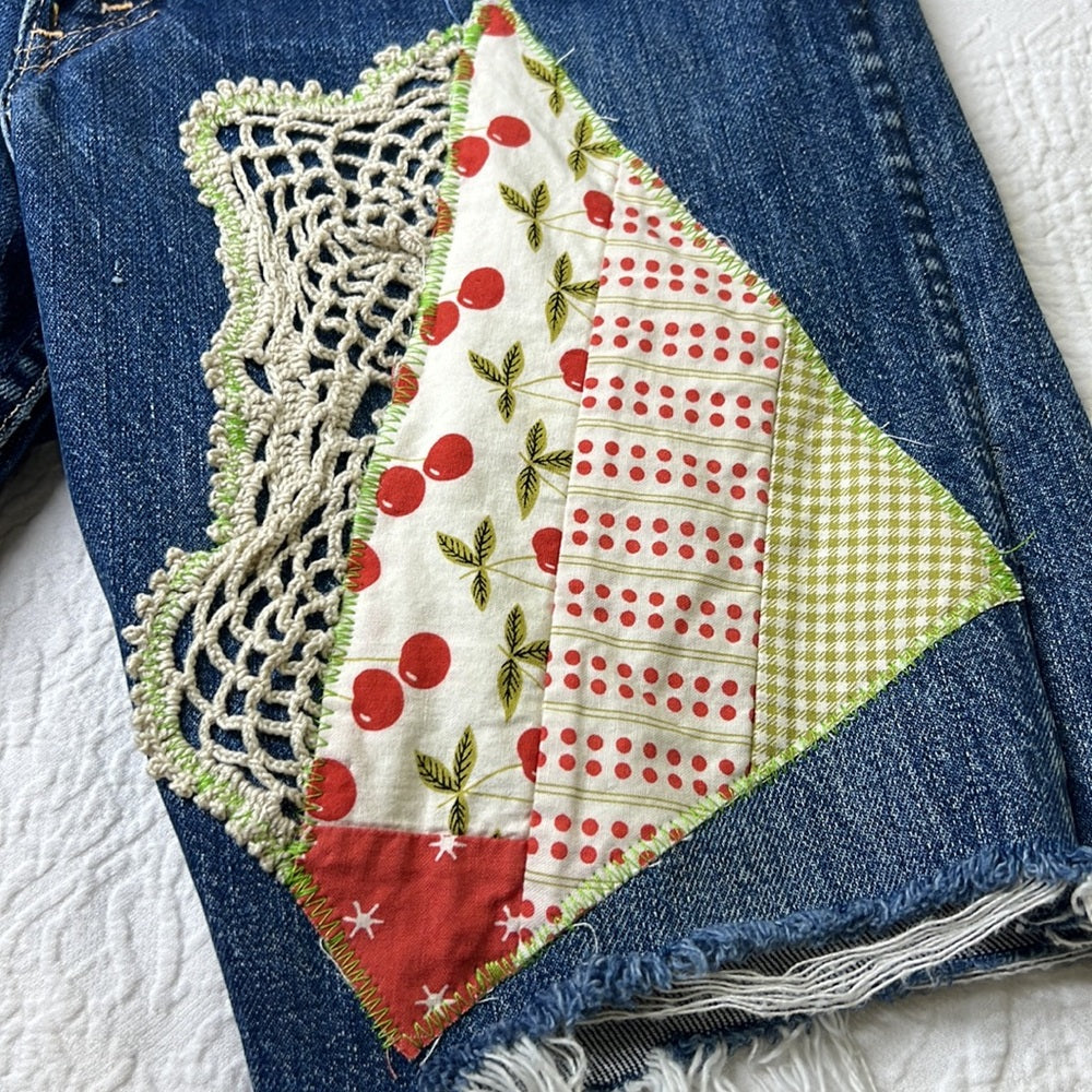 Adorned Crown Textile reworked patch Big E Levi’s cut off shorts upcycle