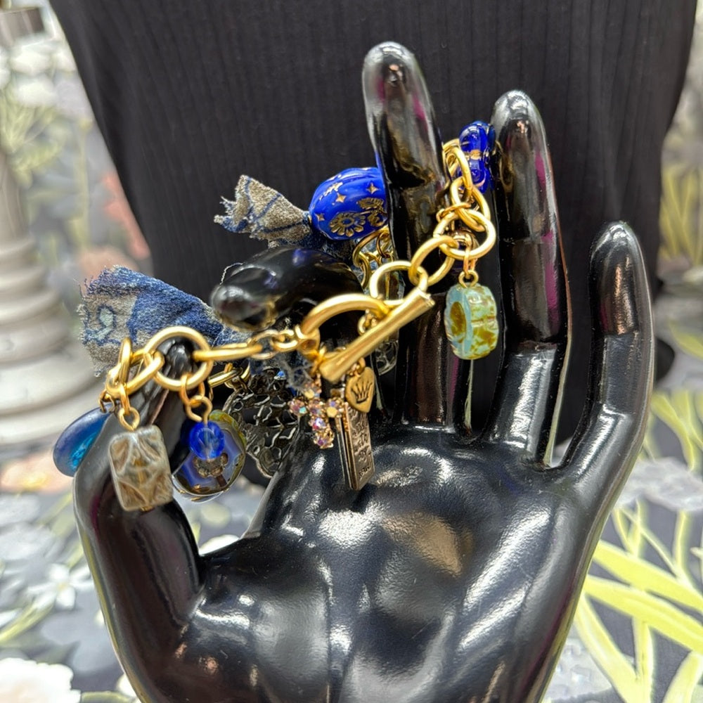 Adorned Crown Jewelry assemblage filigree shades of blue blue charm bracelet