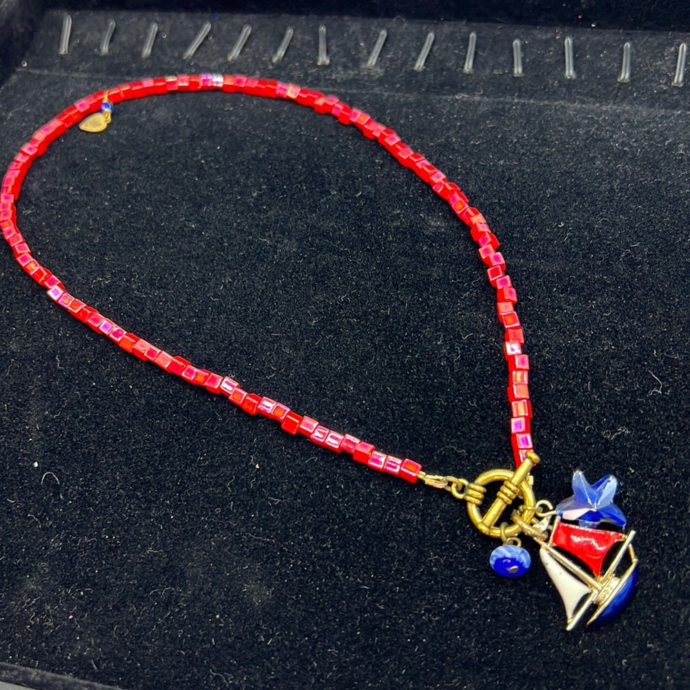 Adorned Crown Assemblage beaches & butterflies bead sailboat charm necklace