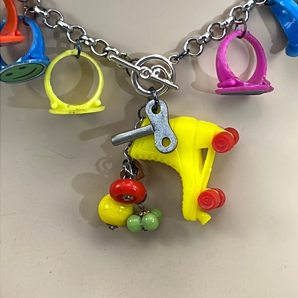 Adorned Crown artisan assemblage child’s roller skate happy face necklace