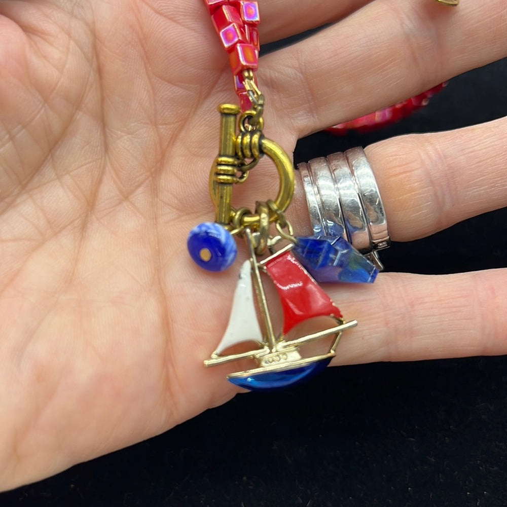 Adorned Crown Assemblage beaches & butterflies bead sailboat charm necklace