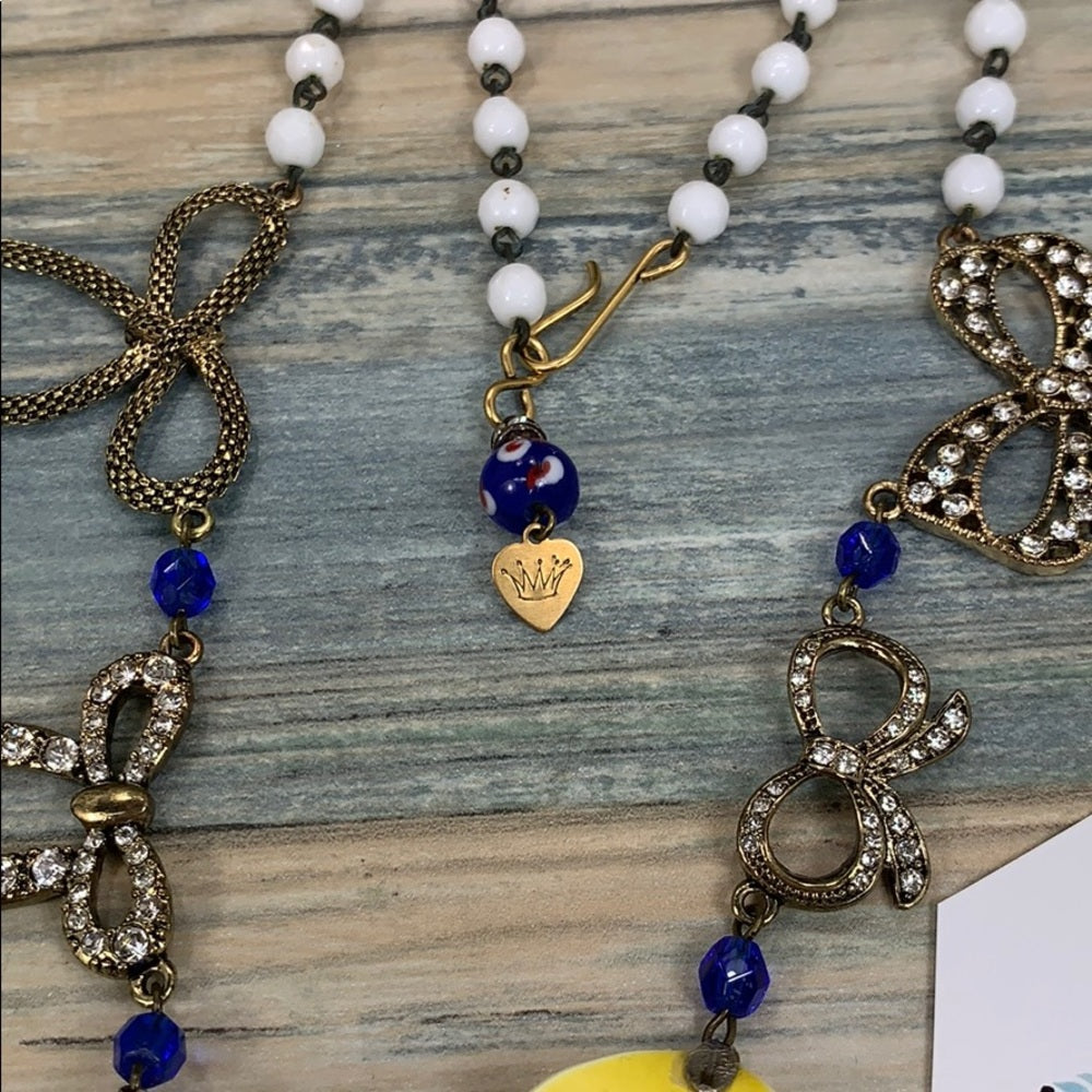 Adorned Crown artisan assemblage yellow enamel flower bow pray necklace