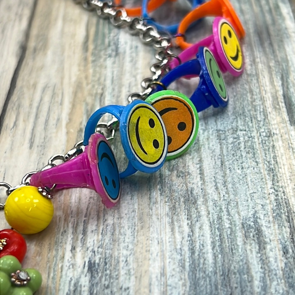 Adorned Crown artisan assemblage child’s roller skate happy face necklace