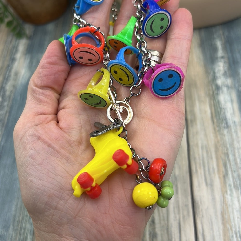 Adorned Crown artisan assemblage child’s roller skate happy face necklace
