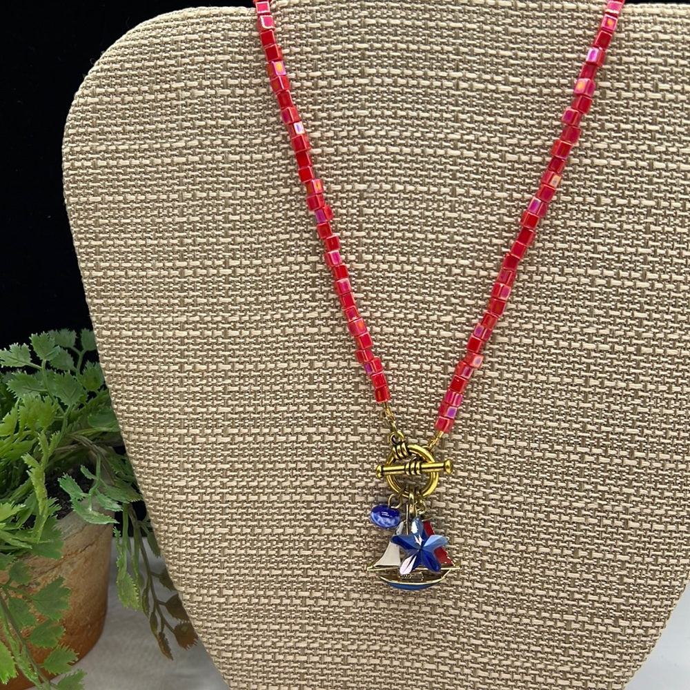 Adorned Crown Assemblage beaches & butterflies bead sailboat charm necklace