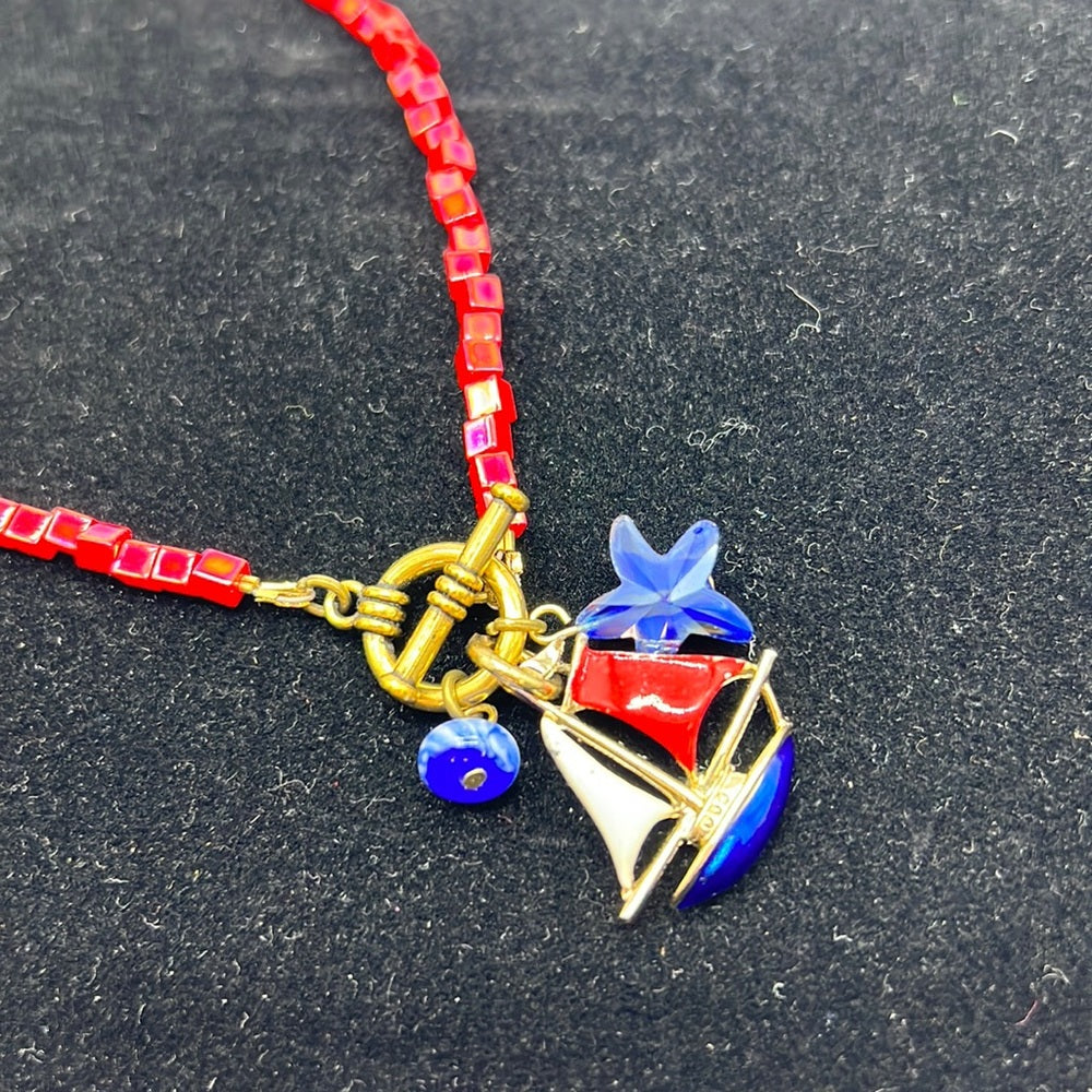 Adorned Crown Assemblage beaches & butterflies bead sailboat charm necklace