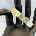 Adorned Crown Trust green stamp cuff bracelet