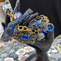 Adorned Crown Jewelry assemblage filigree shades of blue blue charm bracelet