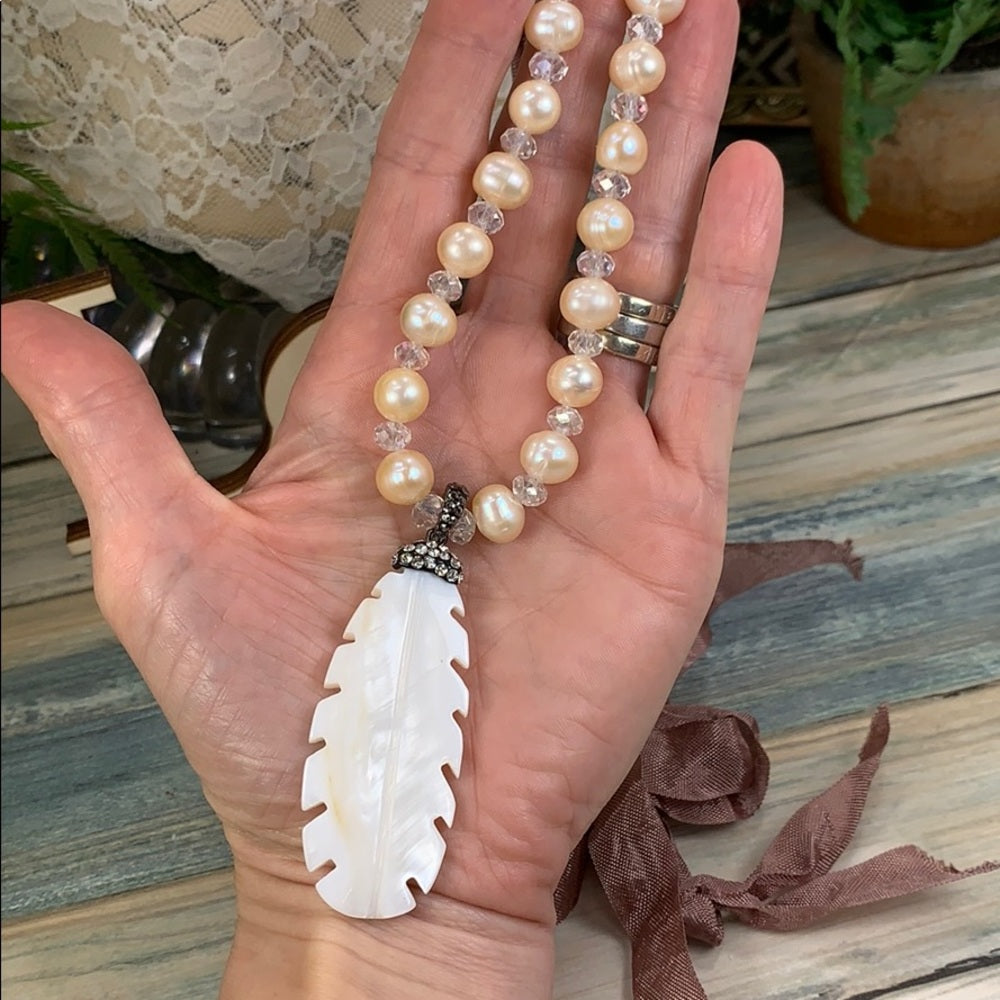 Adorned Crown artisan assemblage carved shell feather pearl silk necklace