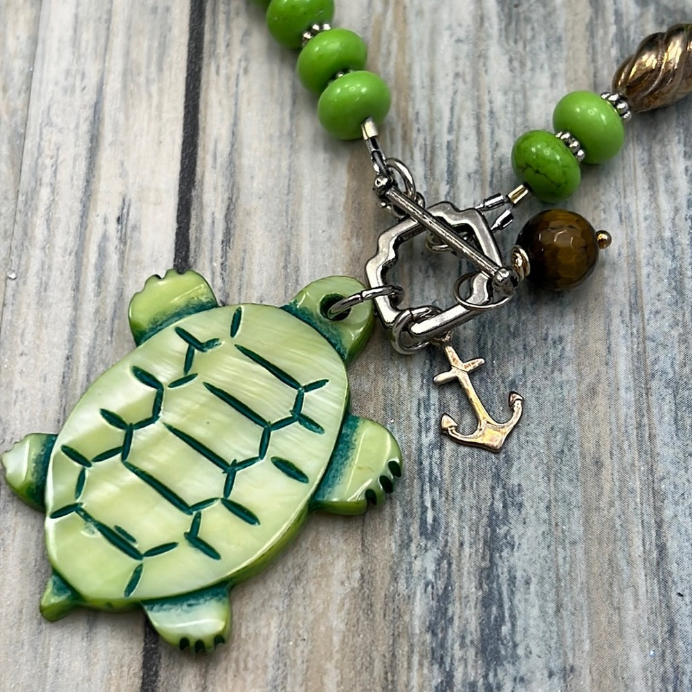 Adorned Crown Assemblage beaches & butterflies turtle anchor necklace