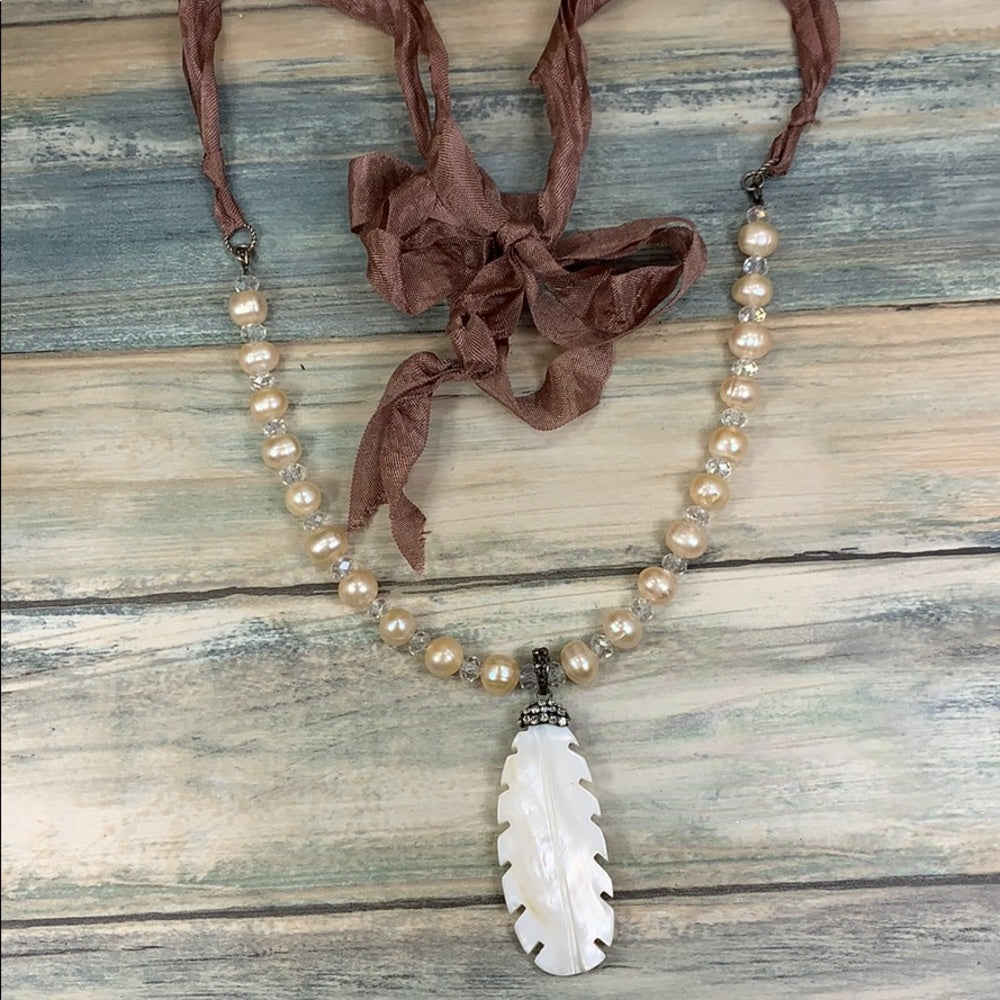 Adorned Crown artisan assemblage carved shell feather pearl silk necklace