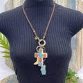 Adorned crown artisan assemblage turquoise cross bone larimar drop necklace